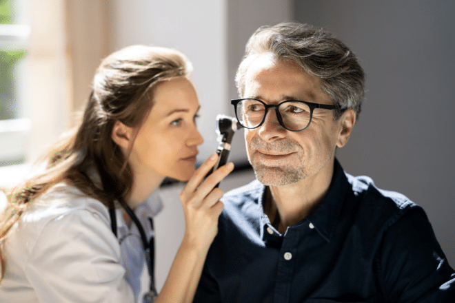 Audiologist checking her patient